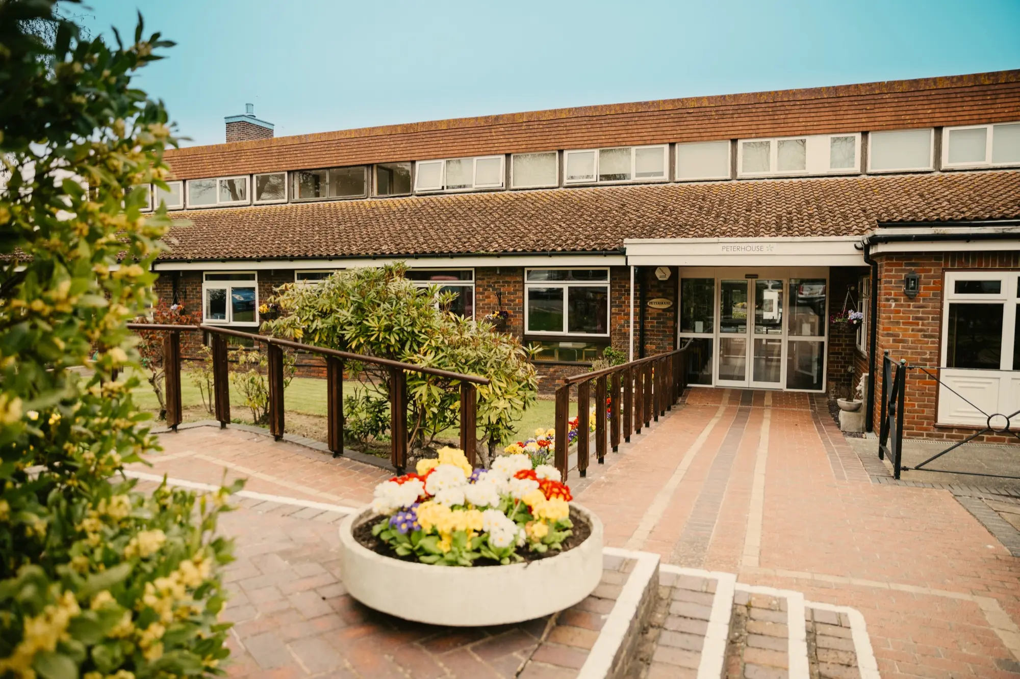 Exterior and courtyard at St Peter's Care and Nursing Home
