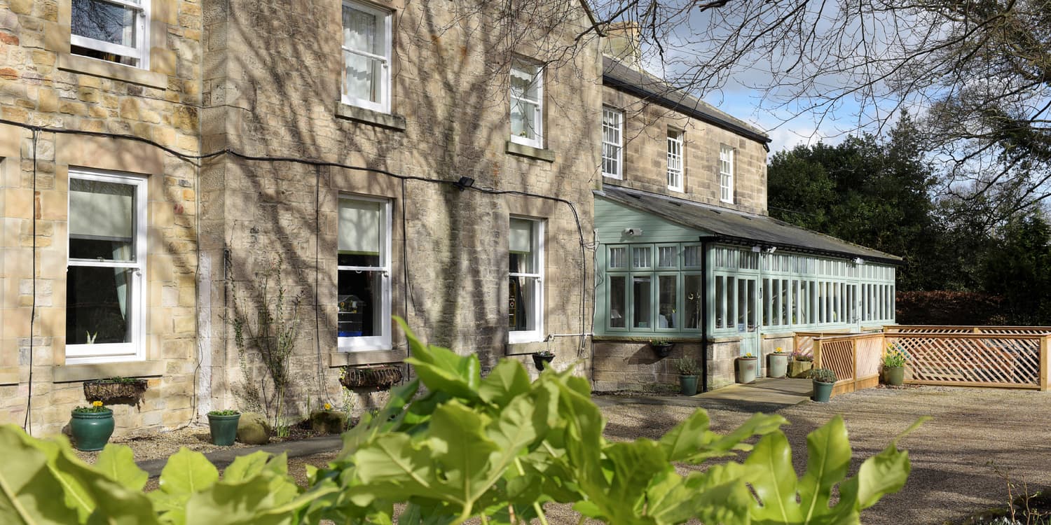 Exterior and conservatory at Wellburn House